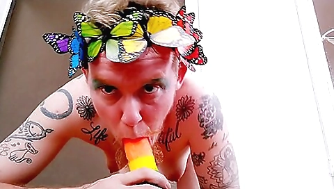 Red-haired tattooed guy gets big dildo shoved into his black cock