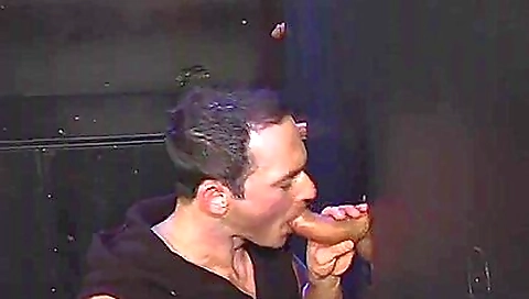 Gloryhole performer is blowing two hard dicks and is getting a facial