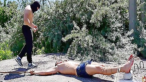 Brunette in bondage suit gets her ass fucked outdoors