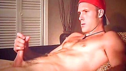 Brunette with a red ballcap takes her hands up against her tits
